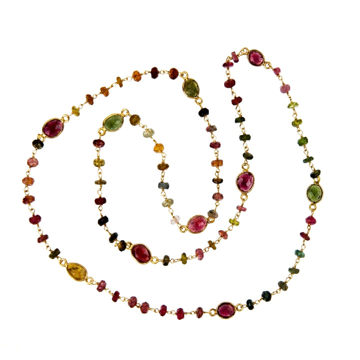 Multi-coloured tourmaline necklace with gold on a white background