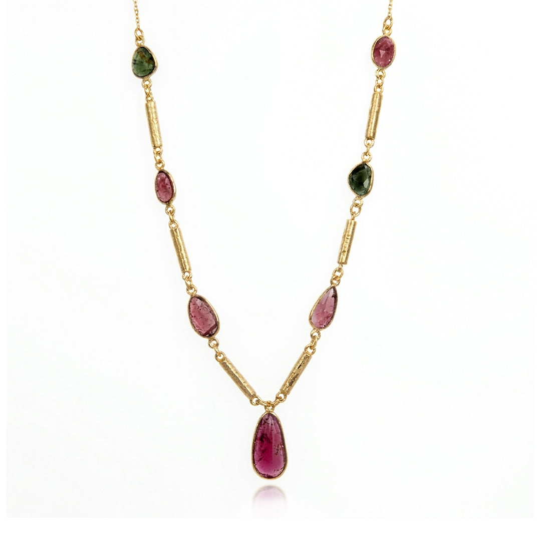 Gold multi-colour tourmaline necklace with a pendant gemstone on a white background.