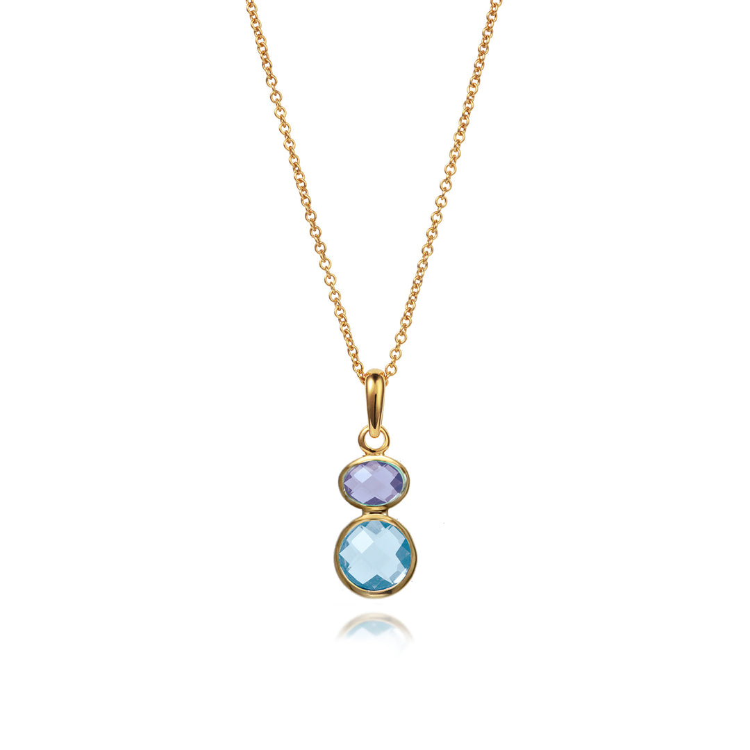 Gold necklace with blue topaz and amethyst gemstones on a white background