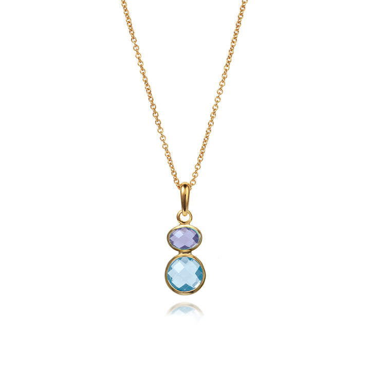 Gold necklace with blue topaz and amethyst gemstones on a white background