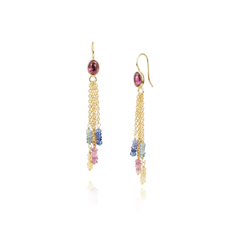 Gold drop earrings with tourmaline and sapphire gemstones on a white background