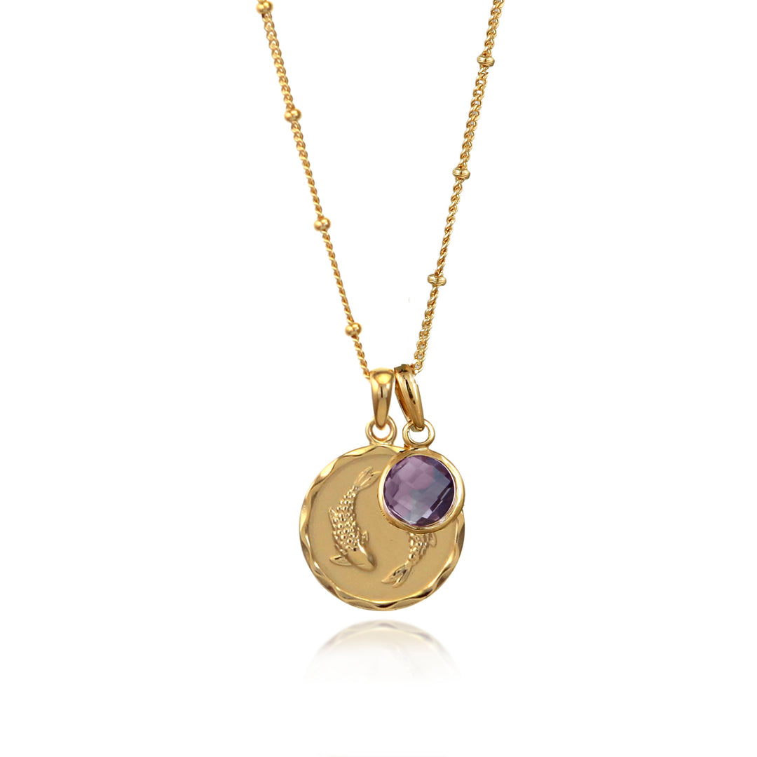 Gold zodiac necklace with pisces star sign and amethyst february charm on white background