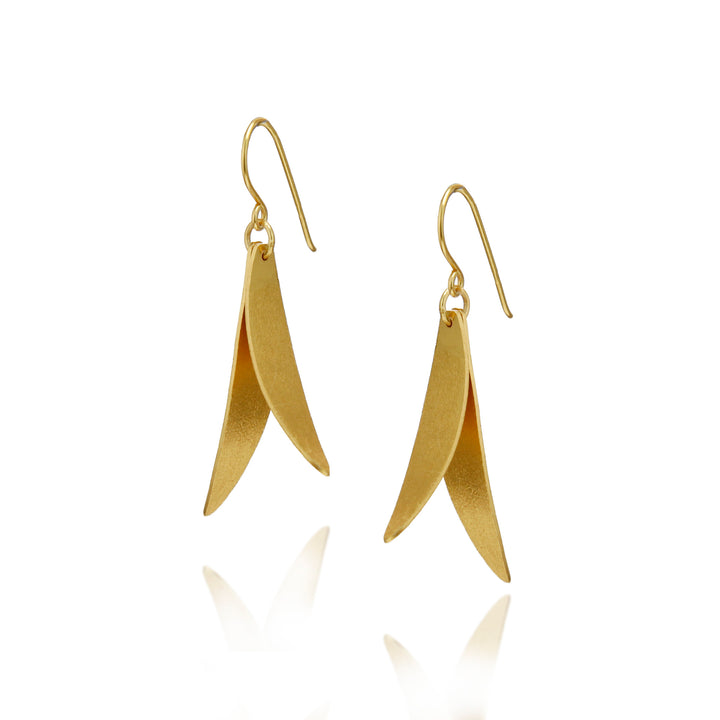 Satin finish gold leaf-shaped earrings on a white background