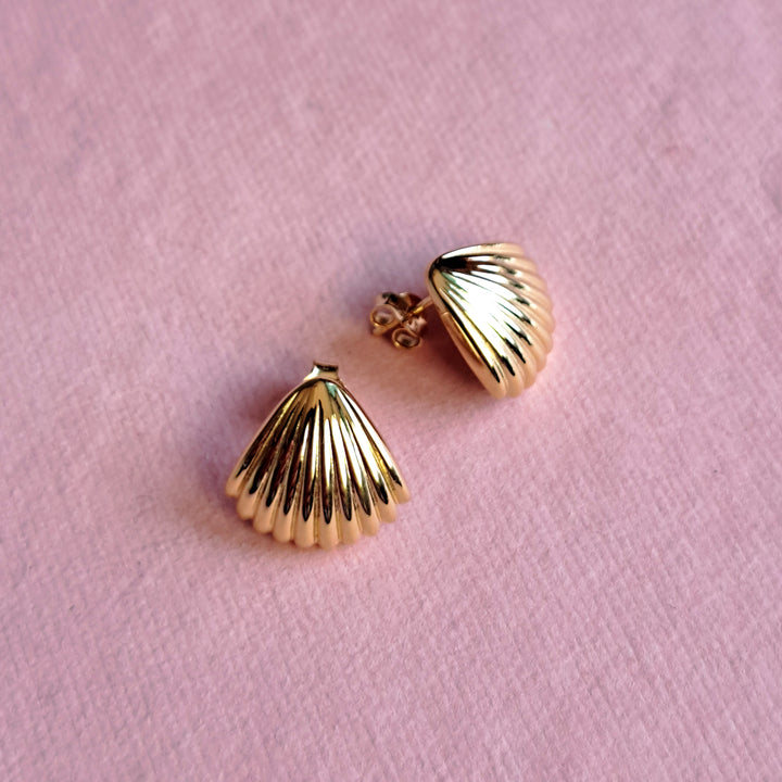 18ct gold vermeil seashell stud earrings  on a pink background