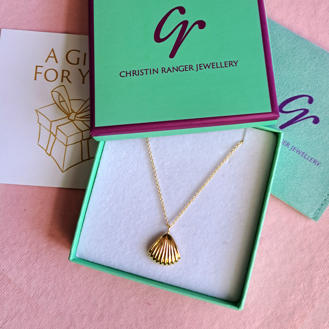 Gold vermeil seashell clam pendant necklace in a Christin Ranger Jewellery gift box