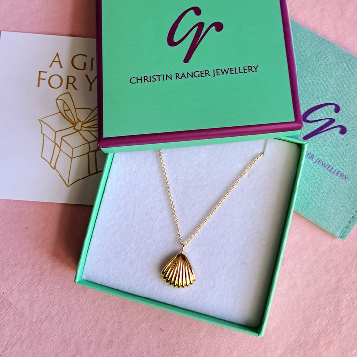 Gold vermeil seashell clam pendant necklace in a Christin Ranger Jewellery gift box