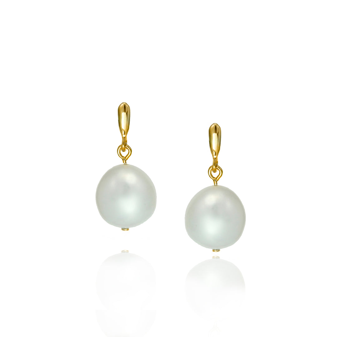 Pair of pearl earrings with gold drops on a white background