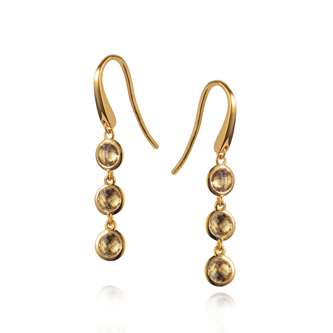 Triple drop gold vermeil earrings set with smoky quartz on a white background