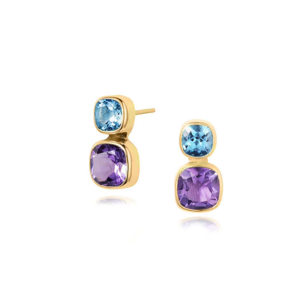 Gold earrings with blue topaz and purple gemstones on a white background