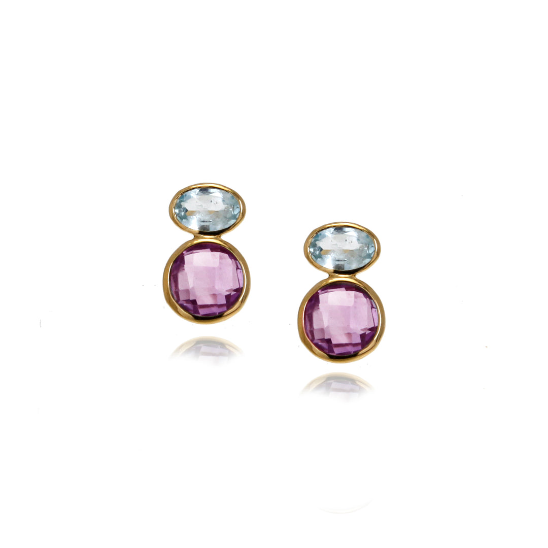 Pair of gold earrings with purple and blue gemstones on a white background