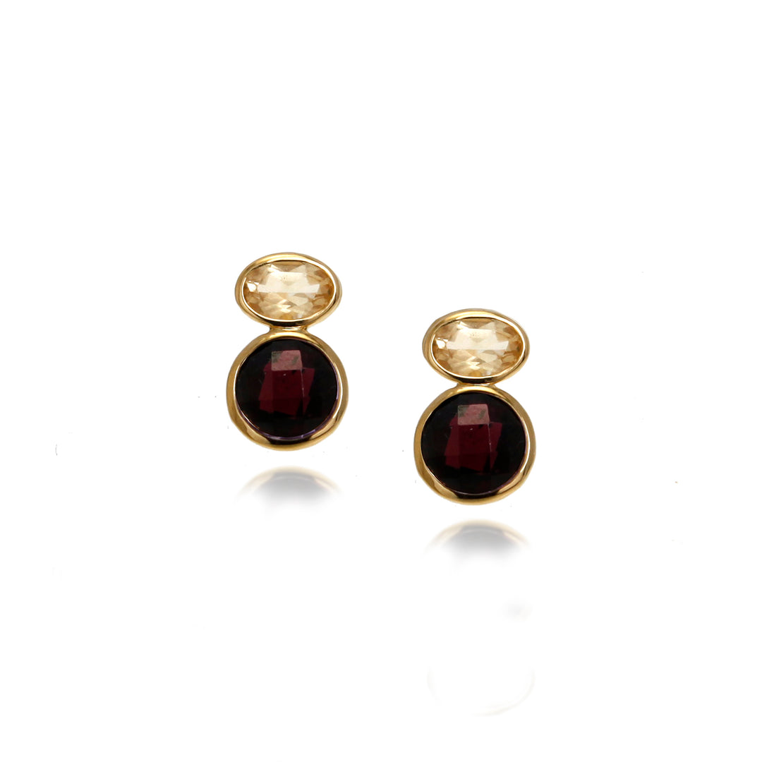 Pair of gold stud earrings with red and yellow gemstones on a white background