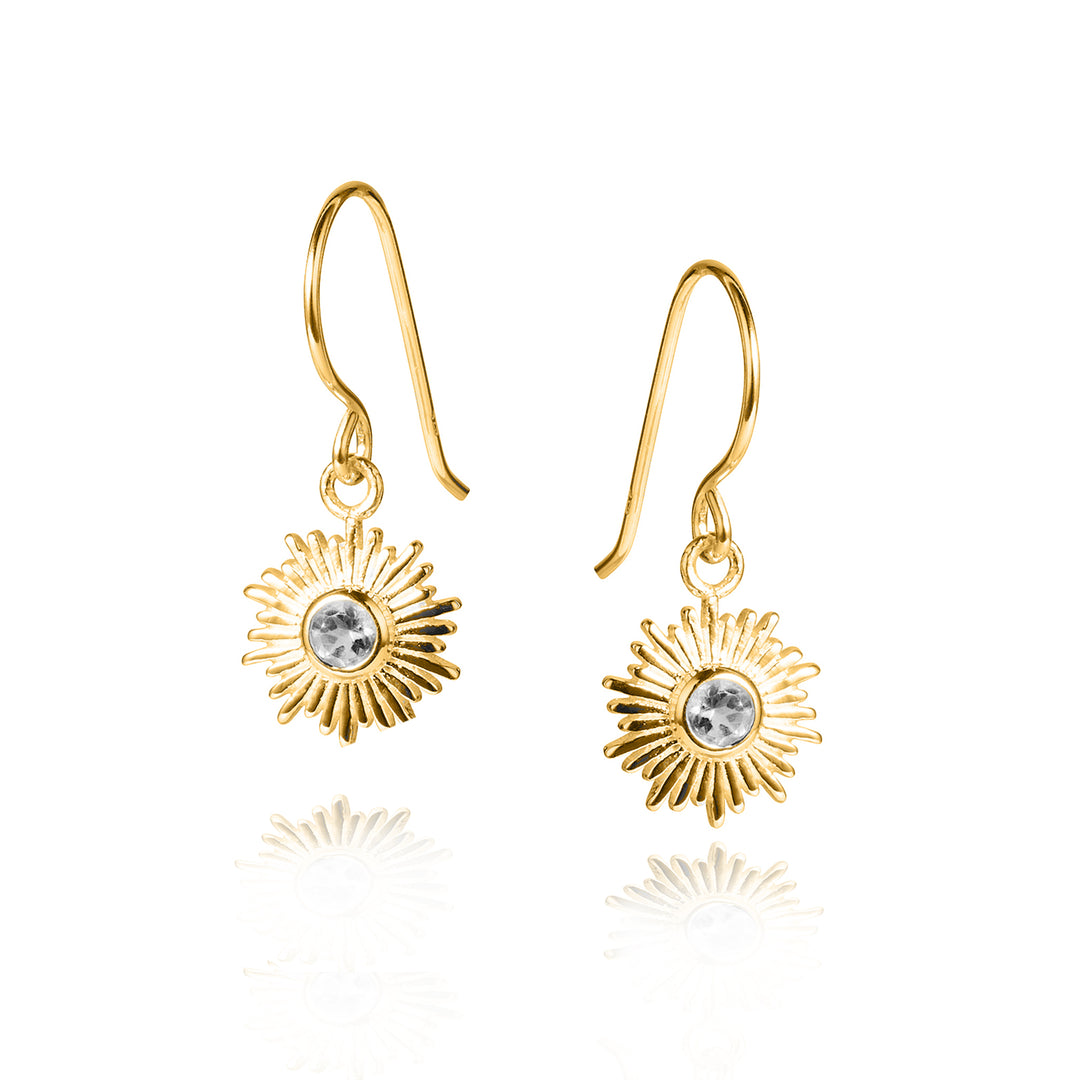 Gold drop earrings with a sun design and set with faceted white topaz gemstones