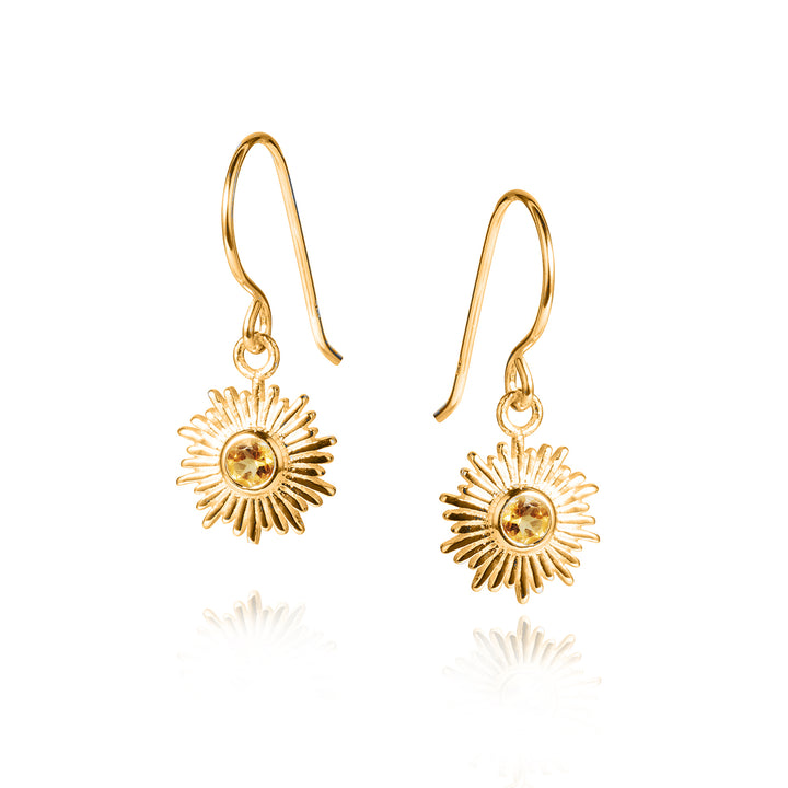 Gold sun drop earrings with golden citrine gemstones on a white background
