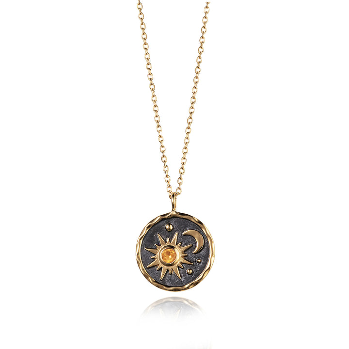 Gold and rhodolite sun and moon pendant with citrine on a white background