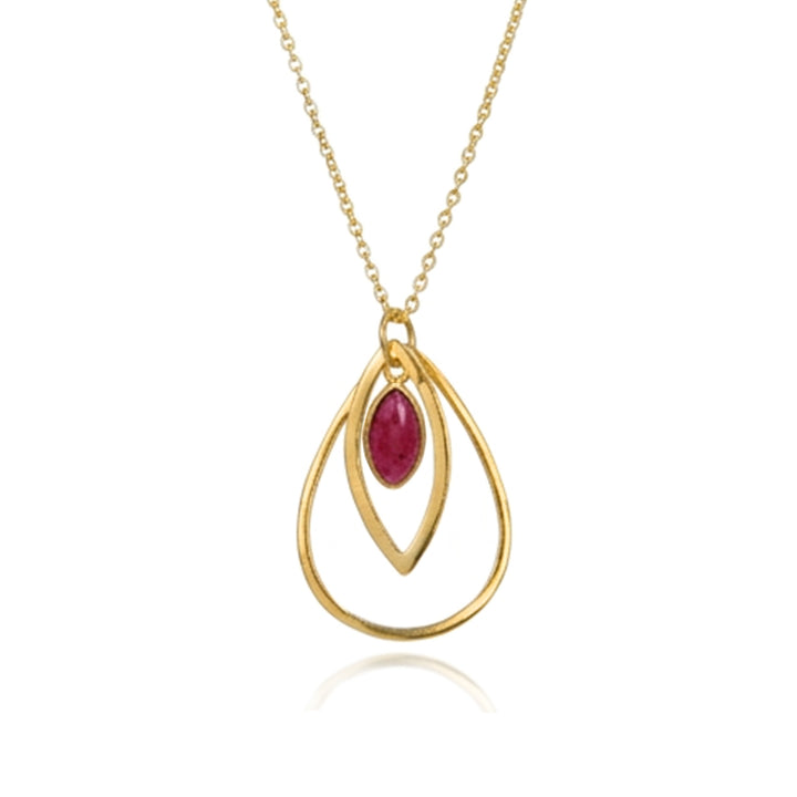 Gold peardrop-shaped pendant with a dark red cabochon gemstone on a white background.