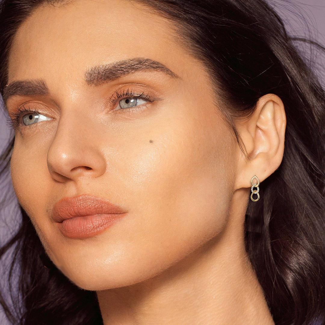 Gold vermeil earrings in a braid design with c-zed on model