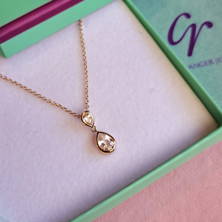 Close-up of gold vermeil two stone pendant necklace in white topaz in a gift box
