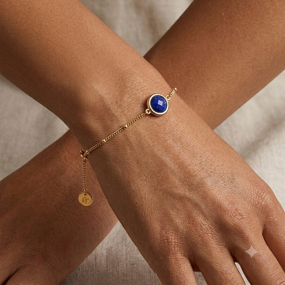 Woman wearing a gold vermeil beaded chain bracelet with lapis lazuli