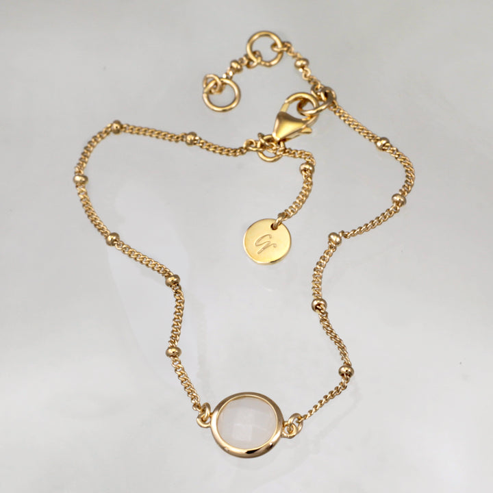 Gold vermeil beaded chain bracelet with moonstone on a reflective background