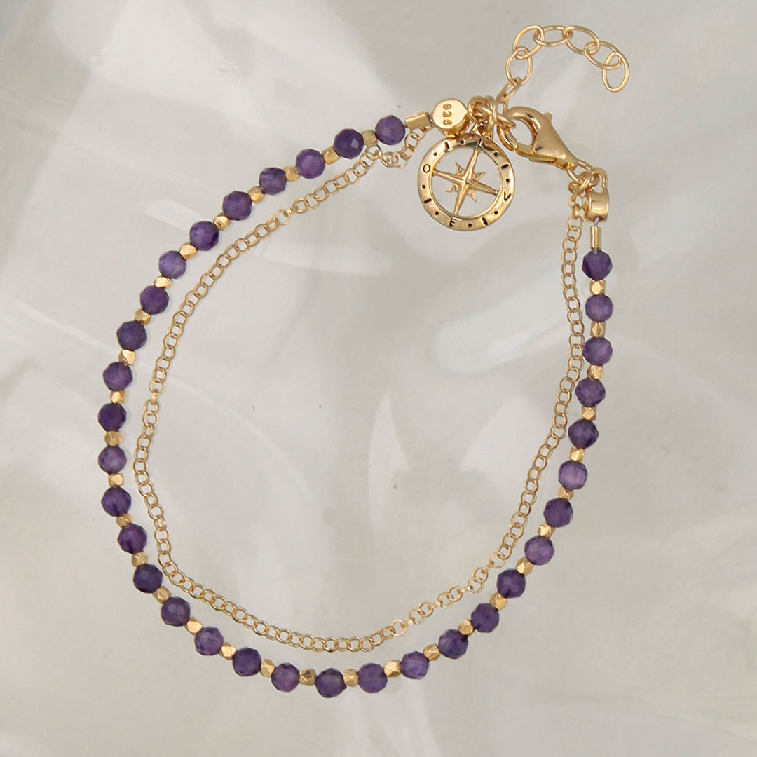 Gold vermeil beaded compass bracelet with amethyst on a reflective background