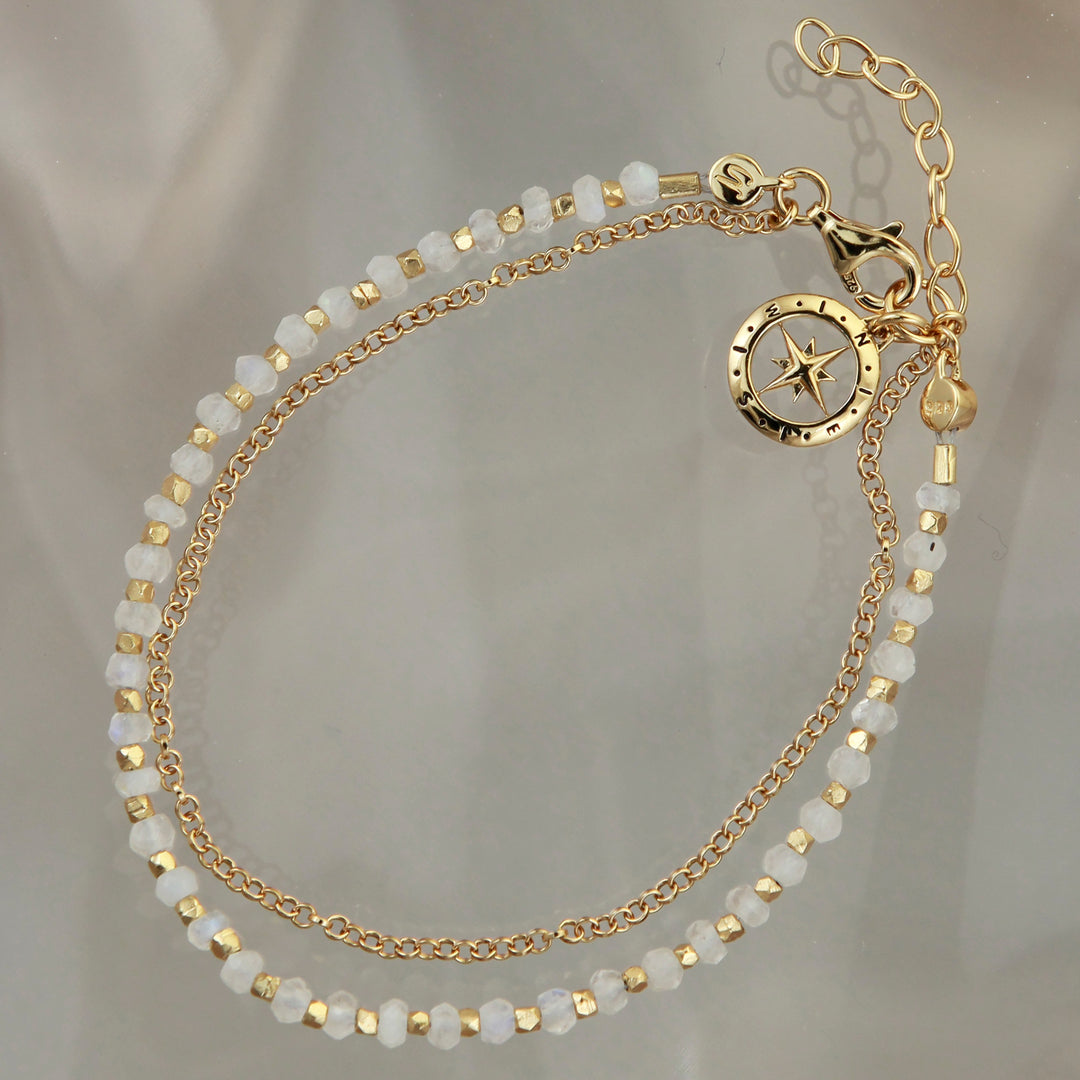 Gold vermeil beaded compass bracelet in moonstone on a reflective background