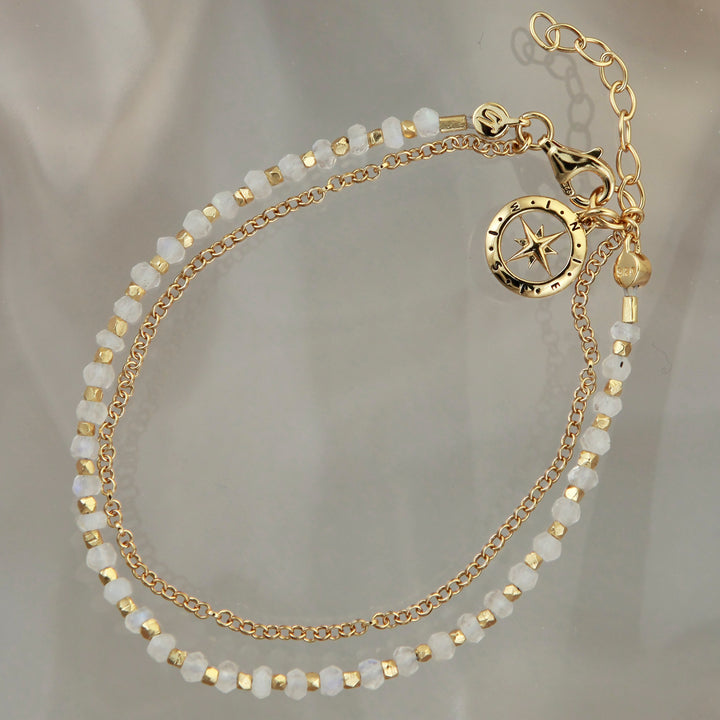 Gold vermeil beaded compass bracelet in moonstone on a reflective background