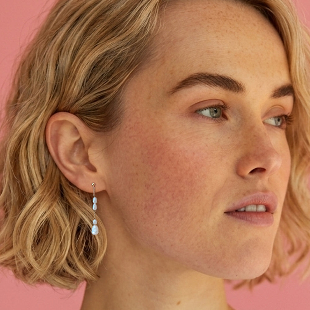 Woman wearing gold vermeil freshwater pearl drop  studs