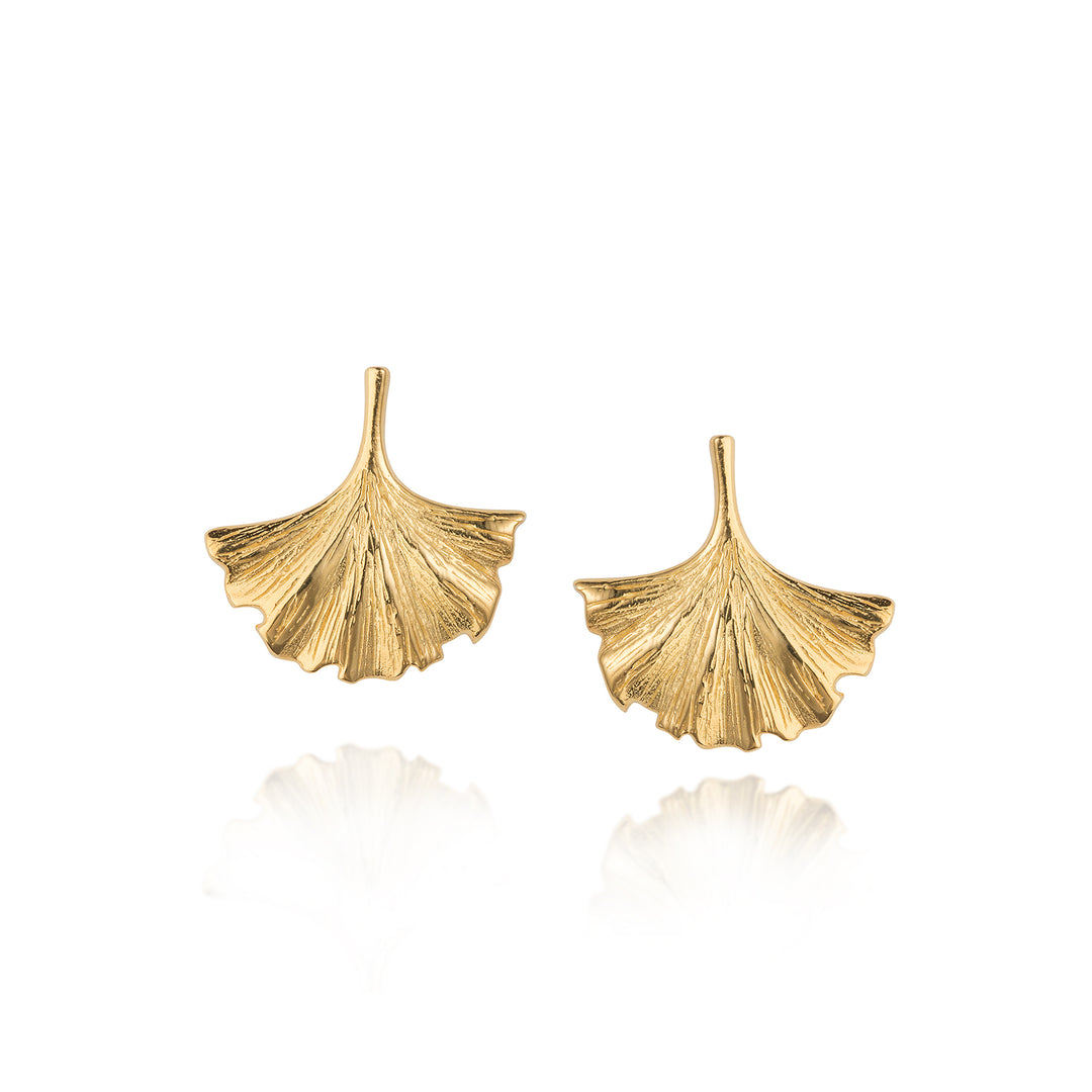 Gold ginkgo leaf-shaped stud earrings on a white background