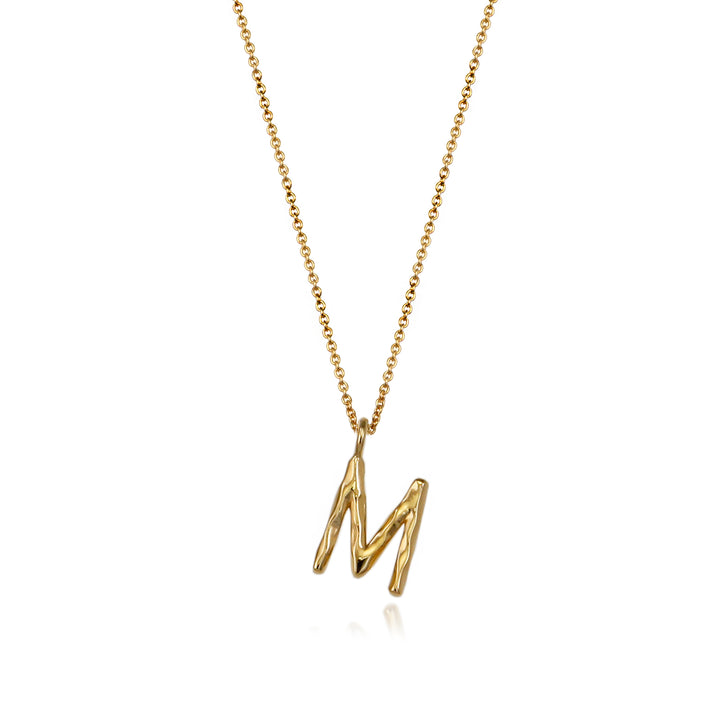 Gold vermeil letter M initial necklace pendant with chain on a white background.