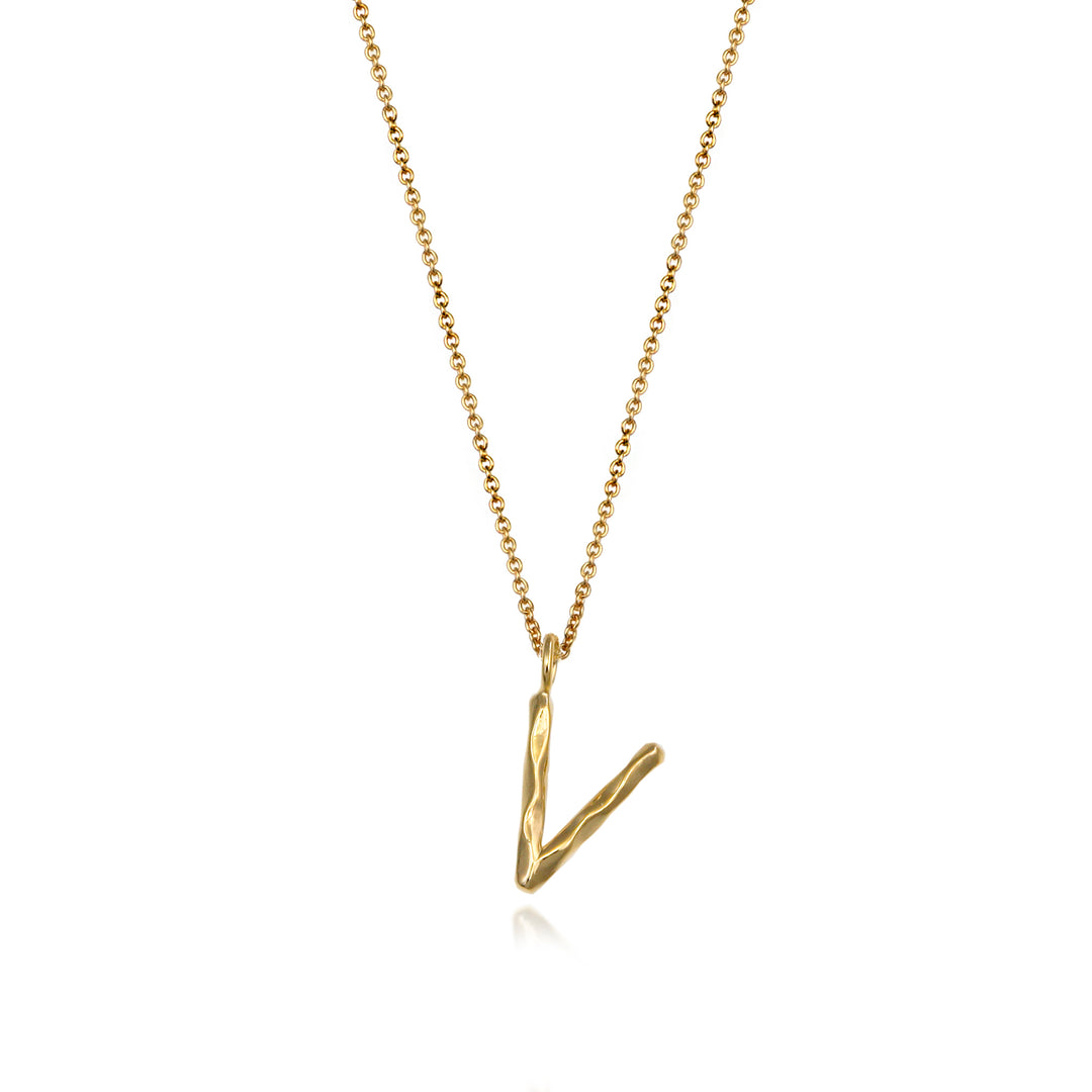 Gold vermeil letter V initial necklace pendant with chain on a white background.