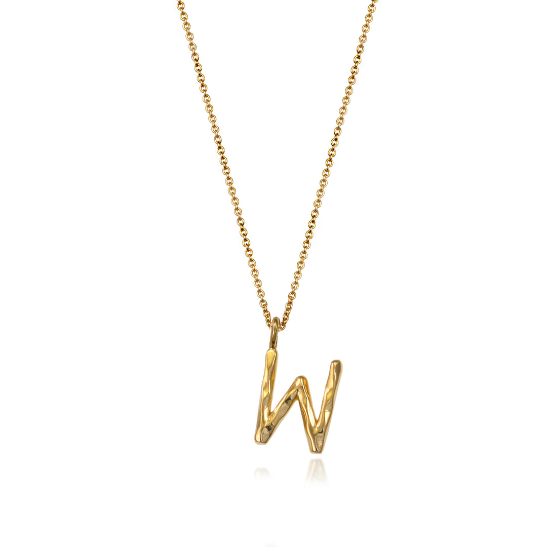 Gold vermeil letter W initial necklace pendant with chain on a white background.