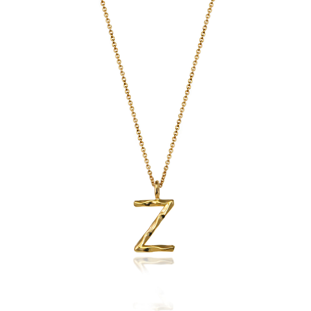 Gold vermeil letter Z initial necklace pendant with chain on a white background.