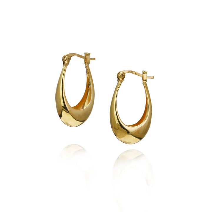 Gold medium oval hoop earrings on a white background