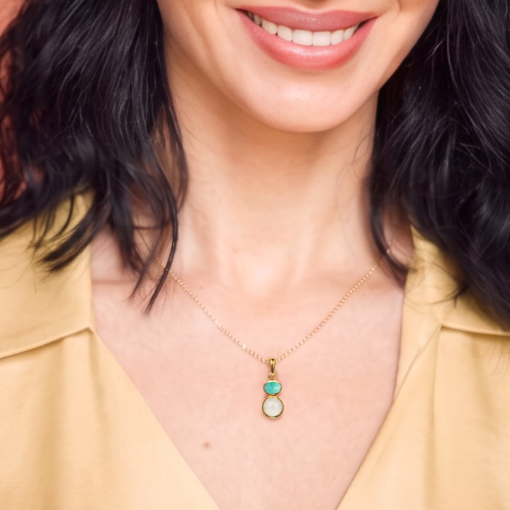Close-up of woman wearing 18ct gold vermeil pendant necklace with moonstone & amazonite
