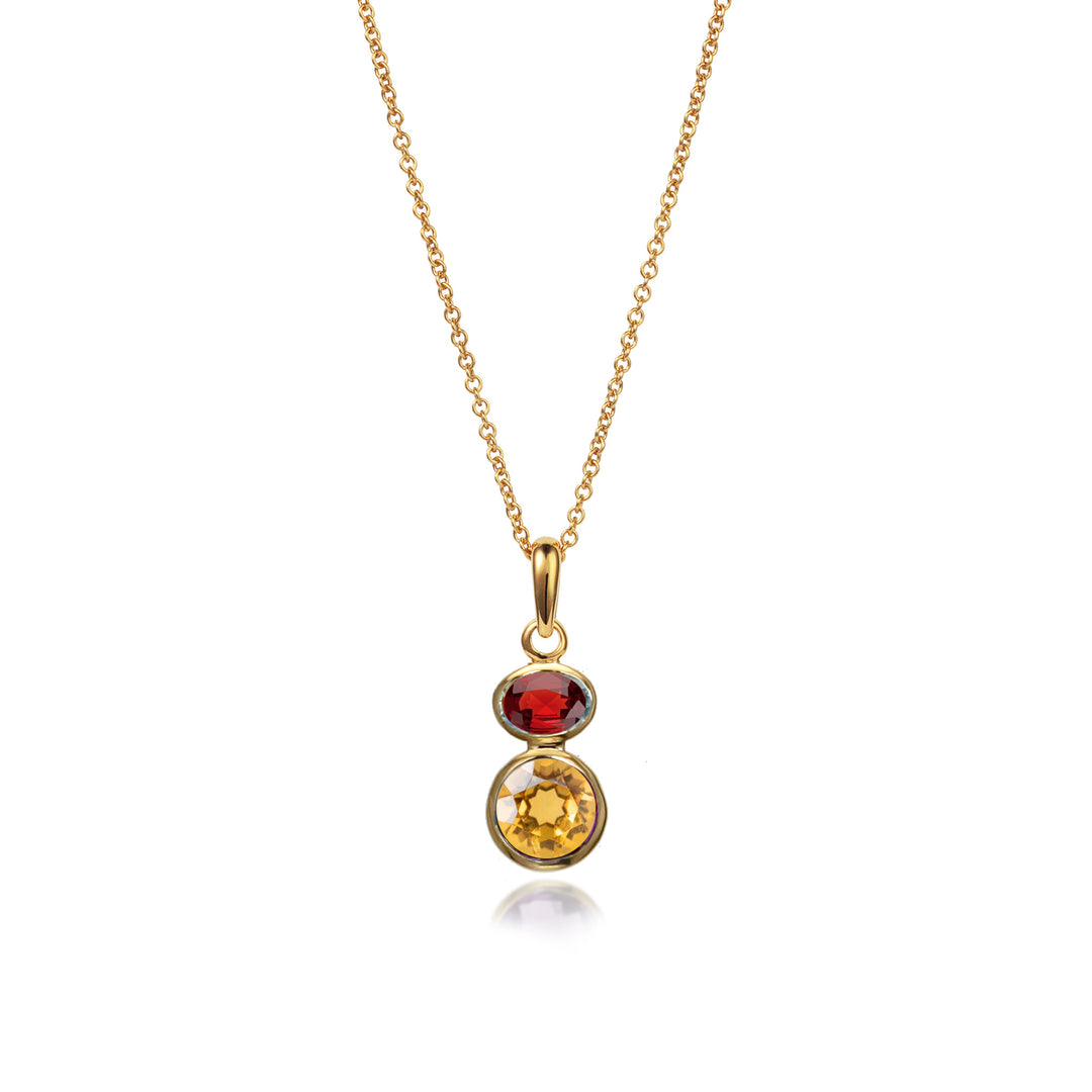 Gold necklace with a pendant featuring two gemstones on a white background