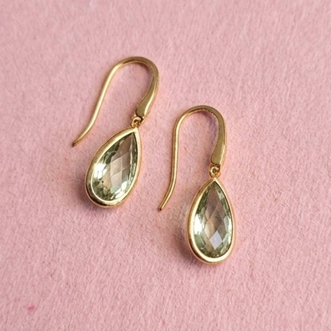 18ct gold vermeil pear drop earrings with green amethyst on pink background