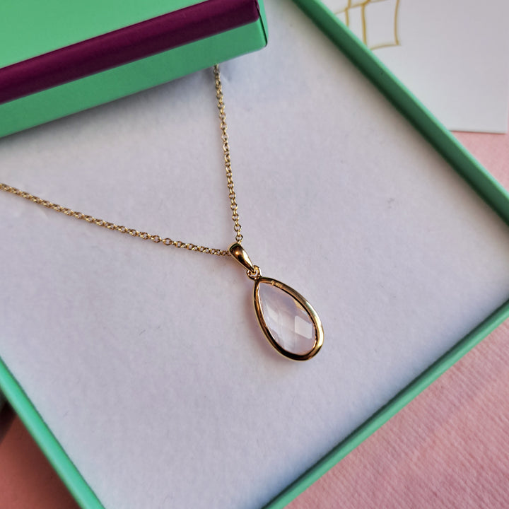Close-up of gold vermeil pear drop pendant necklace with rose quartz