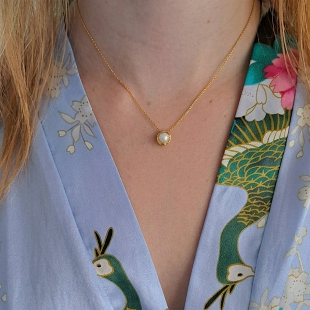 Model wearing a gold vermeil pearl pendant necklace