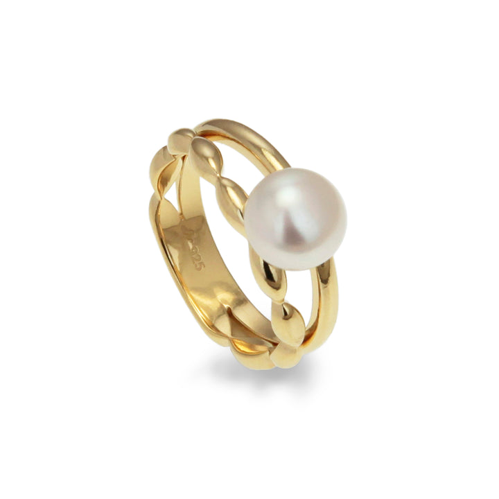 Gold ring with a pearl on a white background