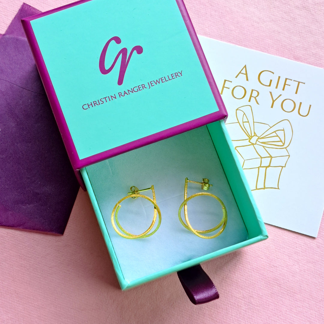 Gold vermeil spiral stud earrings in Christin Ranger Jewellery gift packaging