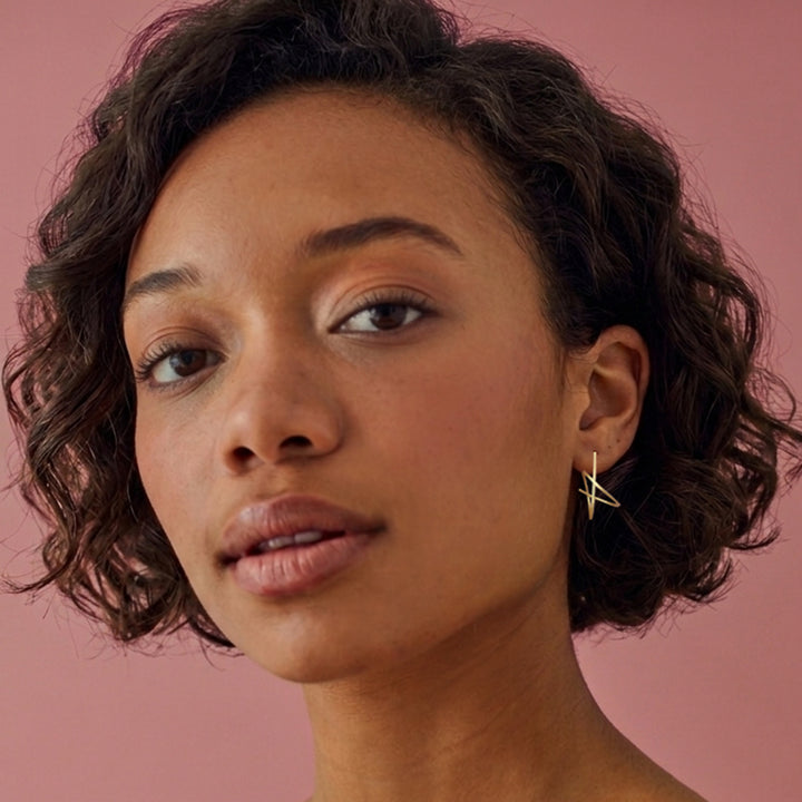Woman wearing Gold vermeil spiral stud earrings