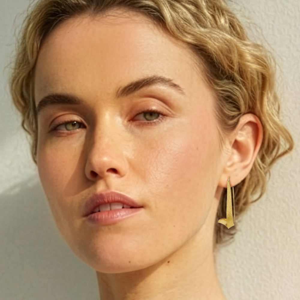 Woman wearing Gold vermeil swirl threader hoop earrings