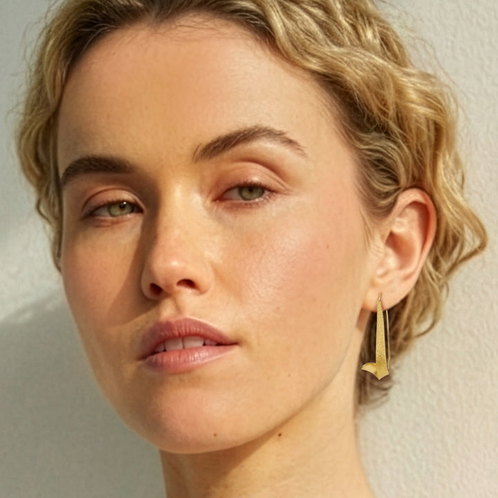 Woman wearing Gold vermeil swirl threader hoop earrings