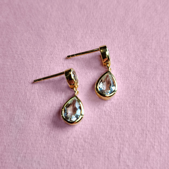14ct gold-vermeil-two-stone-stud-earrings in green amethyst on a pink background