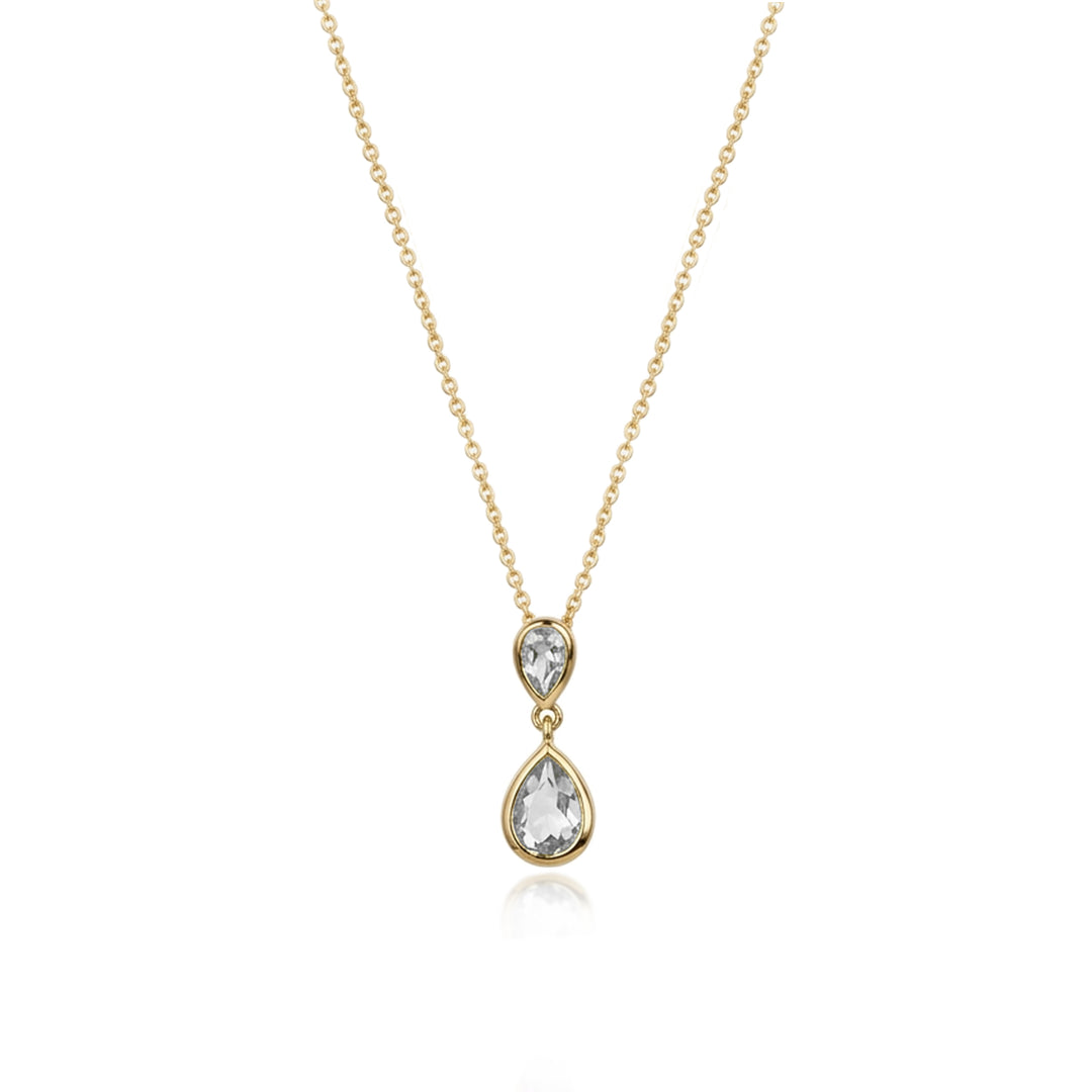 A delicate gold chain necklace featuring a double-drop pendant with a small pear-cut clear gemstone above a larger pear-cut clear gemstone, set in a yellow gold bezel, on a solid white background.