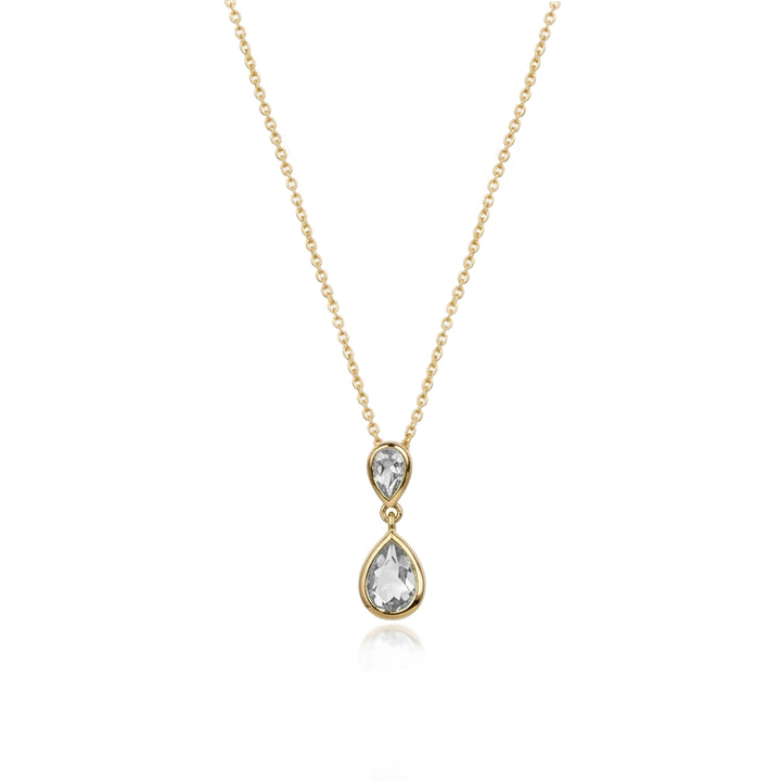 A delicate gold chain necklace featuring a double-drop pendant with a small pear-cut clear gemstone above a larger pear-cut clear gemstone, set in a yellow gold bezel, on a solid white background.