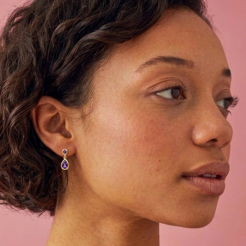 Woman wearing 14ct gold-vermeil-two-stone-stud-earrings-amethyst 