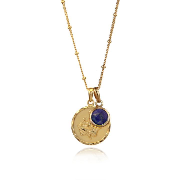 Gold Virgo zodiac pendant and blue lapis September birthstone charm on a white background