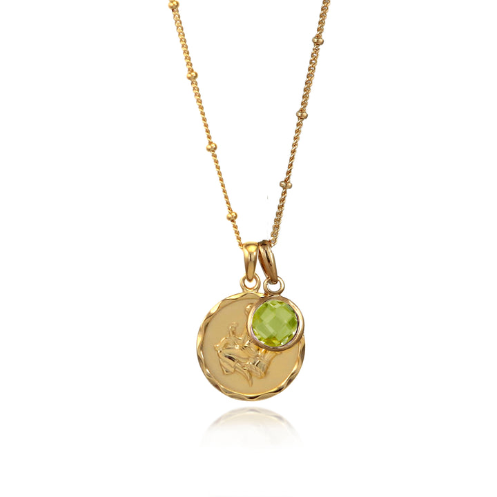 Gold Virgo zodiac pendant necklace with peridot birthstone on a white background