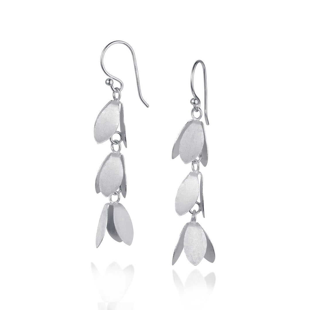 Silver dangle floral earrings on a white background